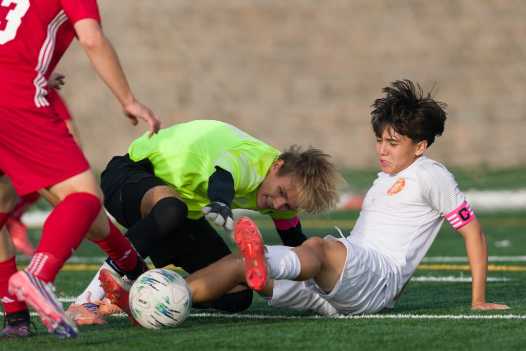 Parsippany goalie Aleks Dobrijevic (left) reaches for the ball over Dover's Ceasar Aguilar (7) in Friday's high school boys soccer showdown in Parsippany. The Tigers plucked the Redhawks, 6-0.  10/09/2026