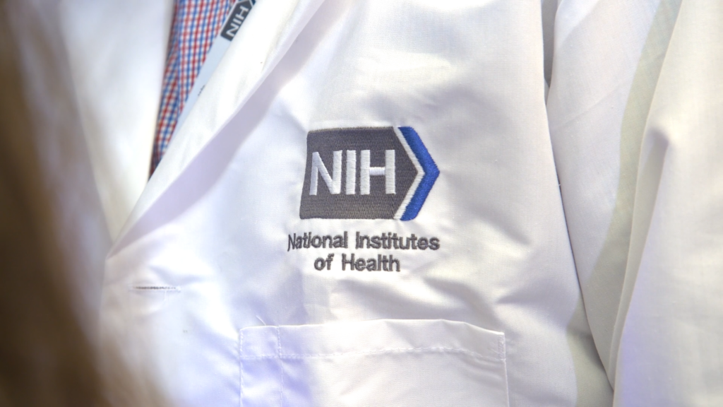 Trump order sets up new women’s health research initiative, White House task force A National Institutes of Health researcher's lab jacket, embroidered with the NIH logo with blue chevron detail. (Photo courtesy NIH)